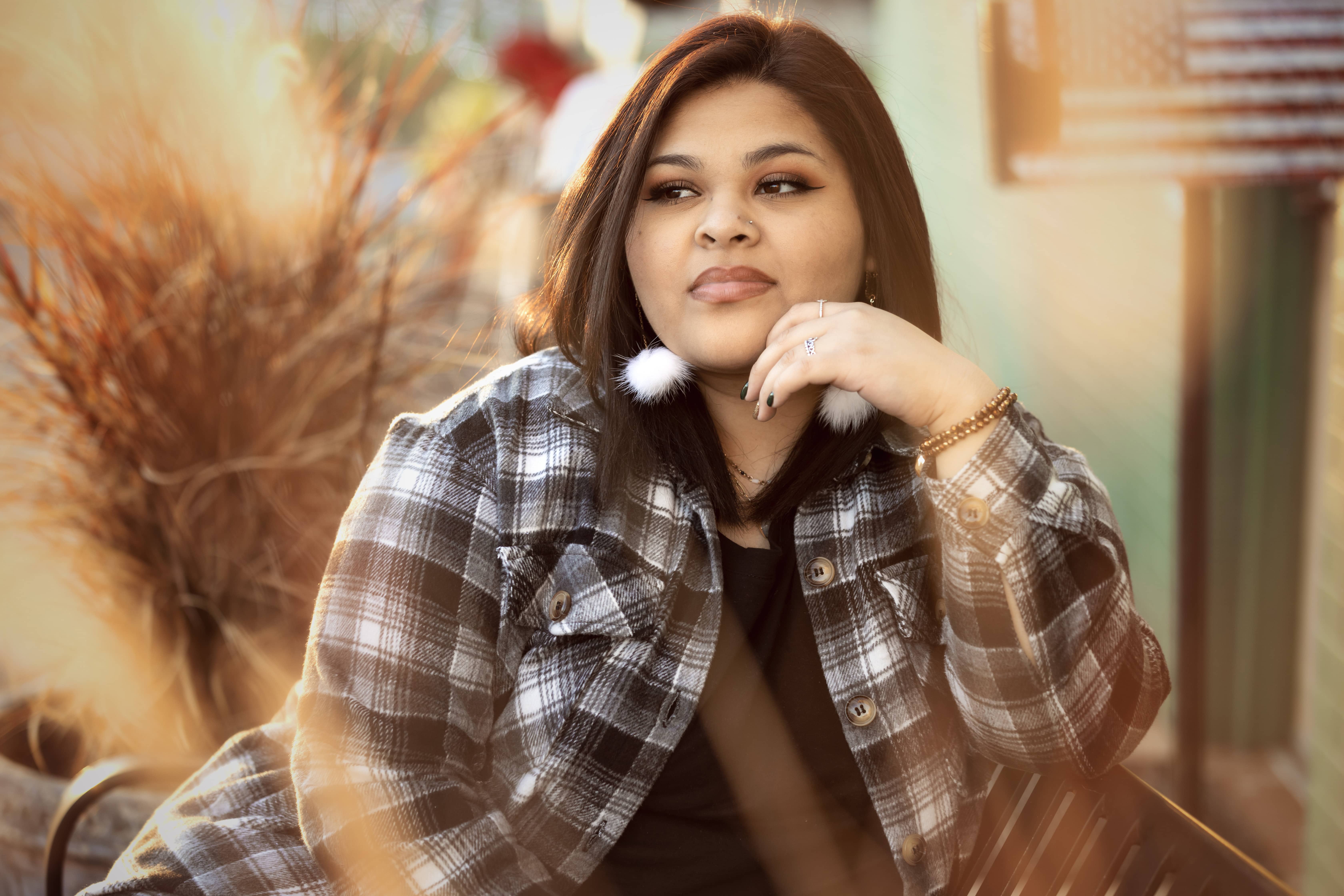 Woman poses with American flag in the background