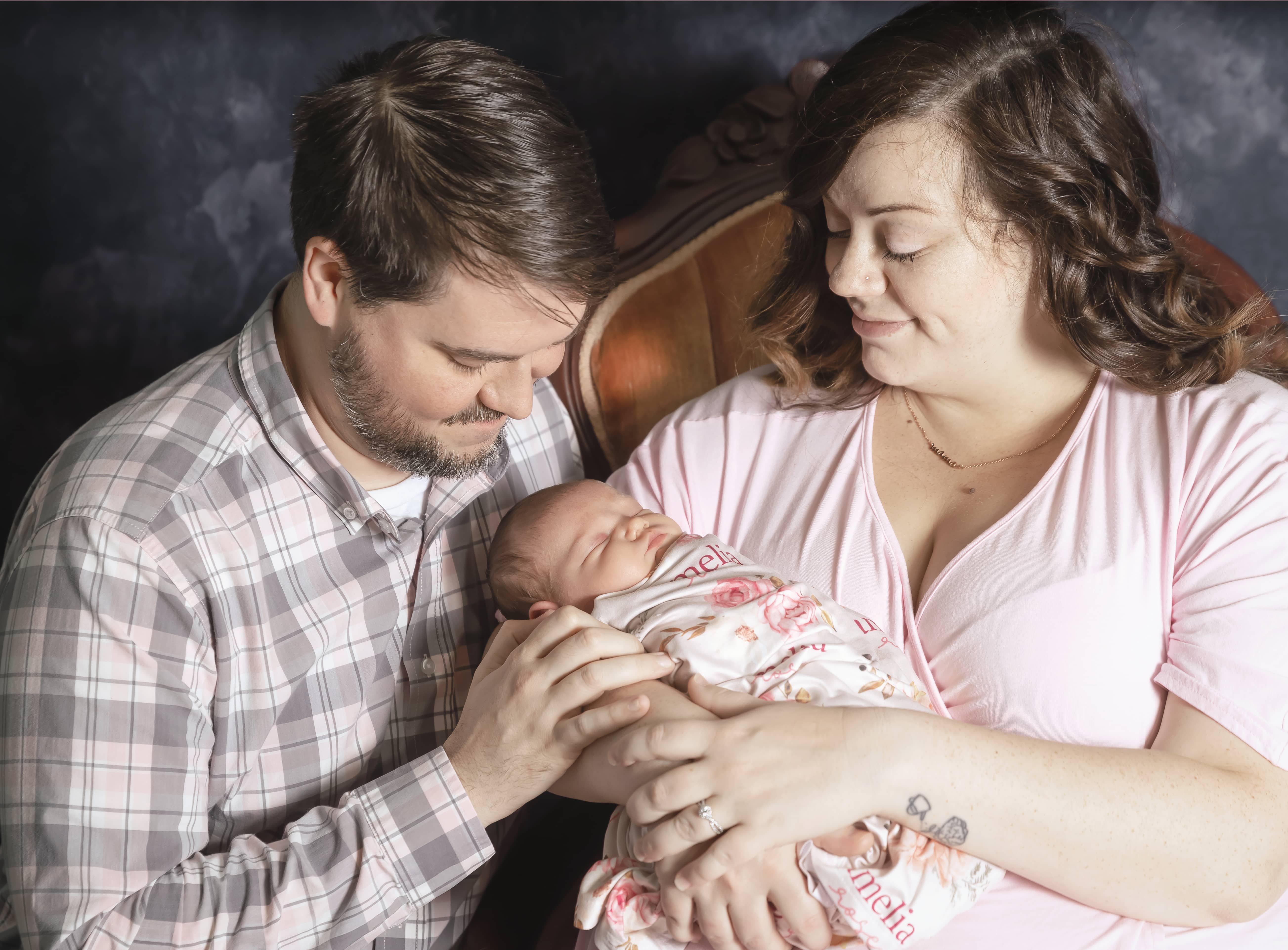 Couple holding their newborn child