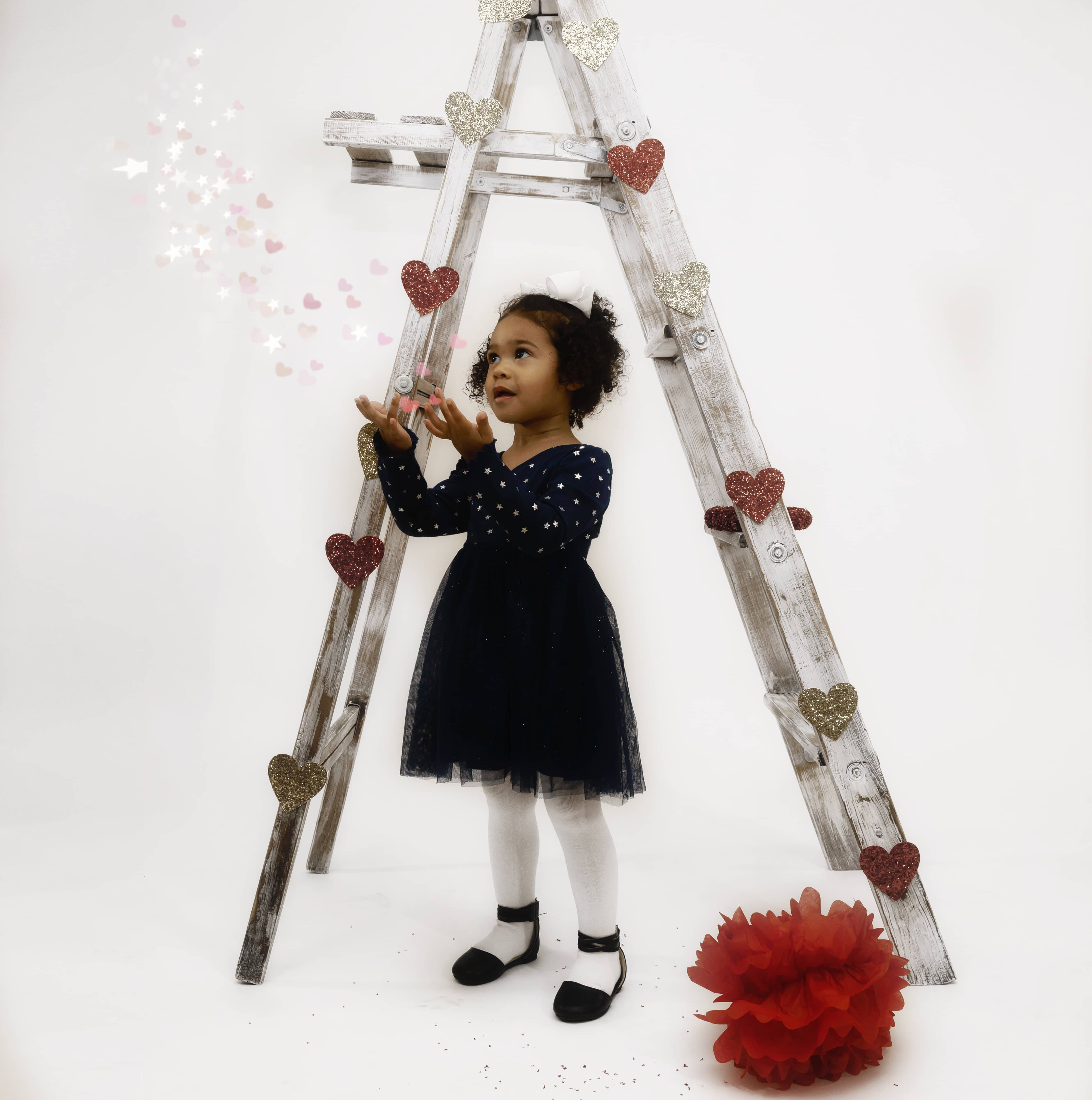 Girl stand next to a prop ladder