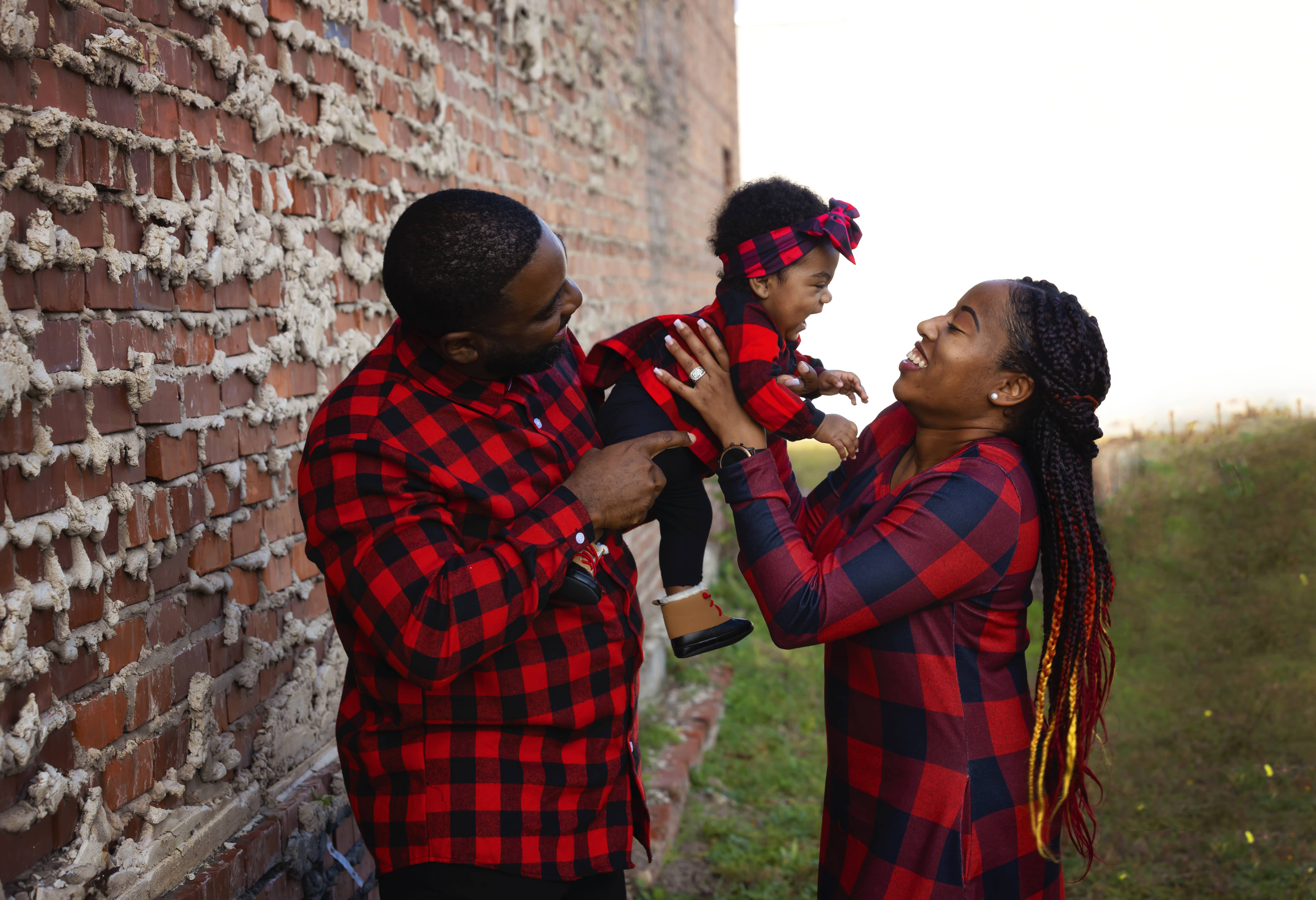 Couple holds their infant child