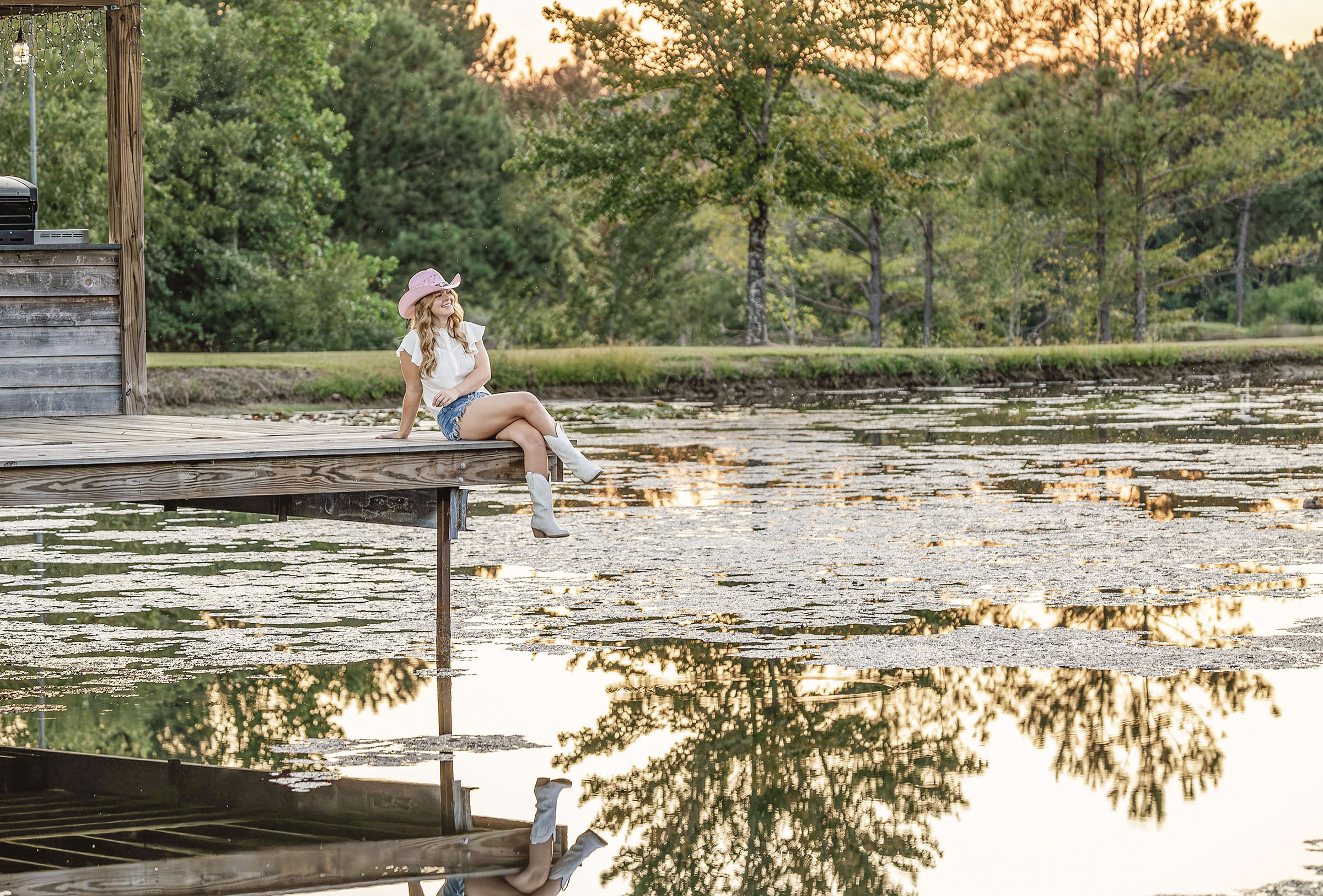 Woman sitting on a dock at a lake