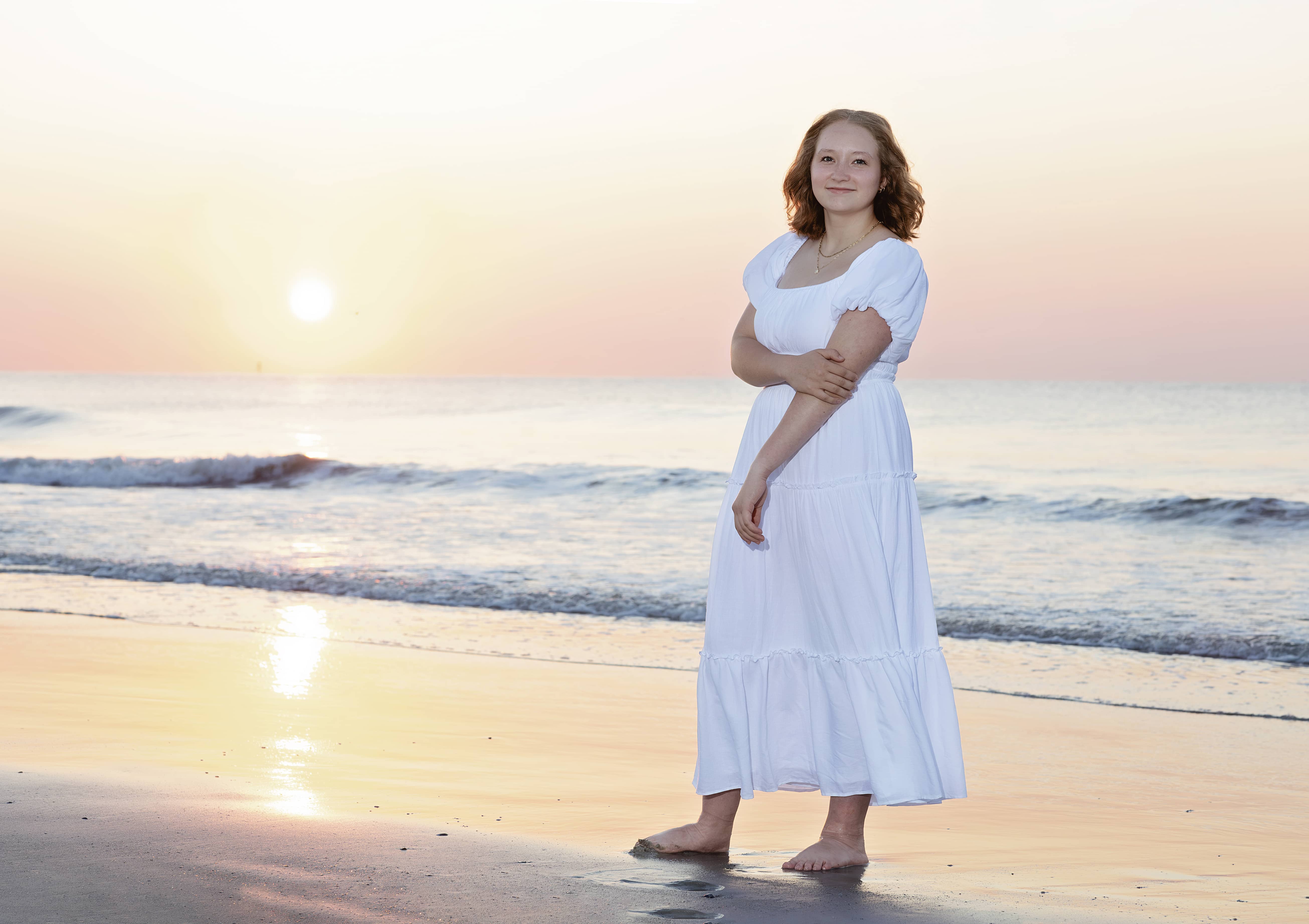 Woman stands on the shoreline at the beach
